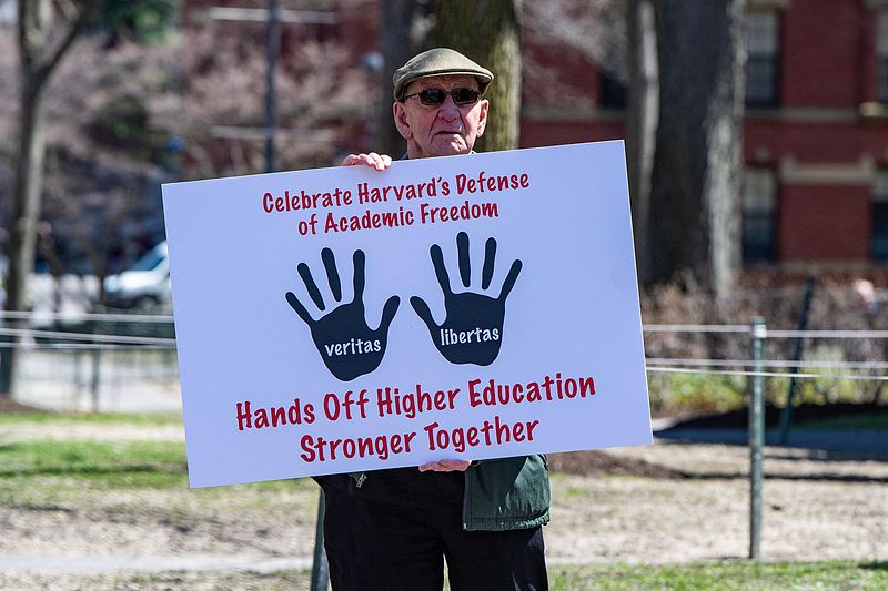 A Harvard Faculty member holds a sign as he exits Harvard Yard after a rally was held against U.S. President Donald Trump's attacks on Harvard University at Harvard University in Cambridge, Massachusetts, April 17, 2025. /CFP